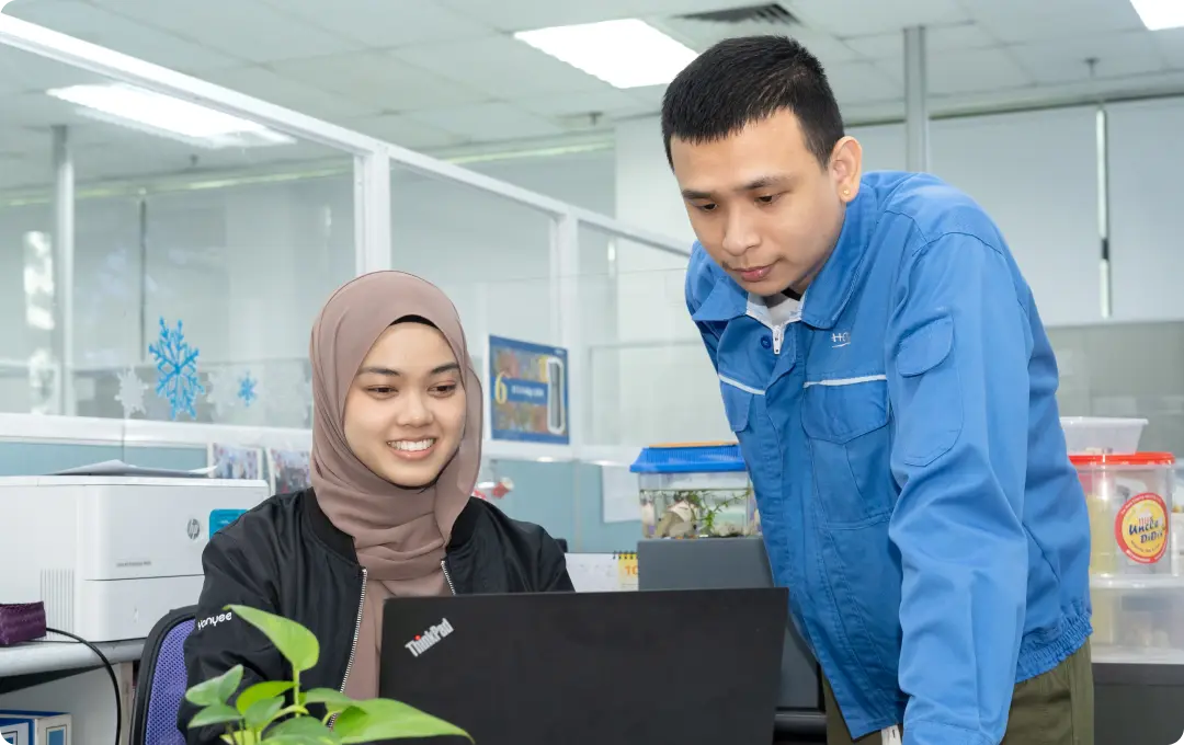HOYA Electronics employees collaborating in the workplace